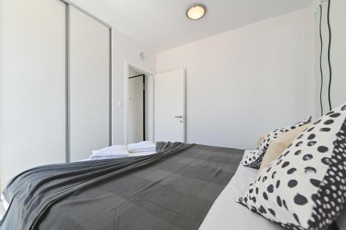 a bedroom with a large mirror on the wall at Azuro Novalja Zrce in Novalja