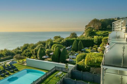 an aerial view of a resort with a swimming pool and the ocean at Luccombe Hall Hotel in Shanklin