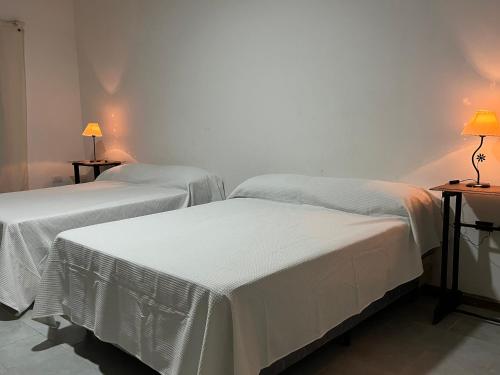 Ένα ή περισσότερα κρεβάτια σε δωμάτιο στο Apart Santa Ana de los Indios Guácaras