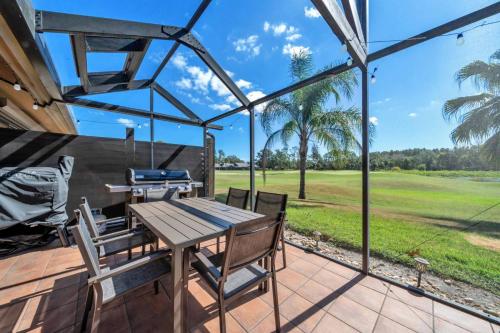 a patio with a table and chairs and a view of a field at Tee Time Tranquility in Zephyrhills
