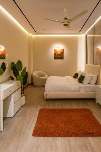 a bedroom with a bed and a couch and a table at Zeta Mall Luxury Apartments by Wall Street Rooftop Pool Access in Islamabad