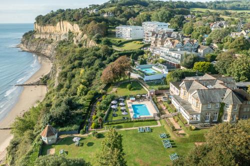 an aerial view of a house on a cliff next to the ocean at Luccombe Manor Country House Hotel in Shanklin
