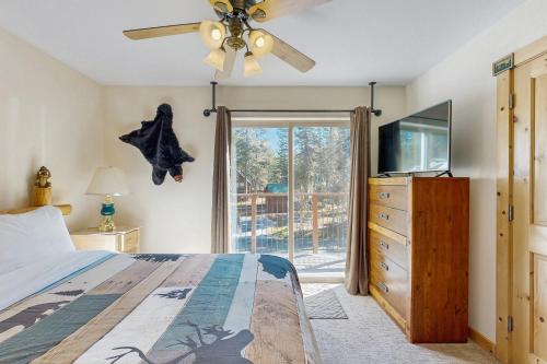 a bedroom with a bed and a ceiling fan at Boat House in Soda Springs