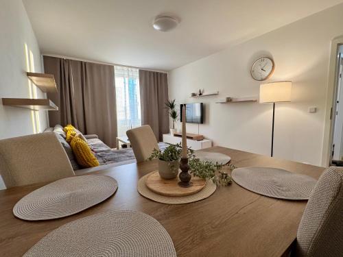 Un comedor con una mesa y una sala de estar. en FH Apartment Letňany, en Praga