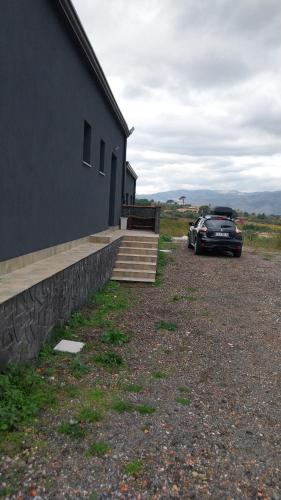 a black car parked next to a building at Il Calice dell'Etna in Passopisciaro