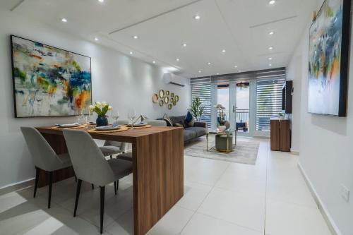 a living room with a wooden table and chairs at Isla Apartment in Ocean Club Rincon in Corcega