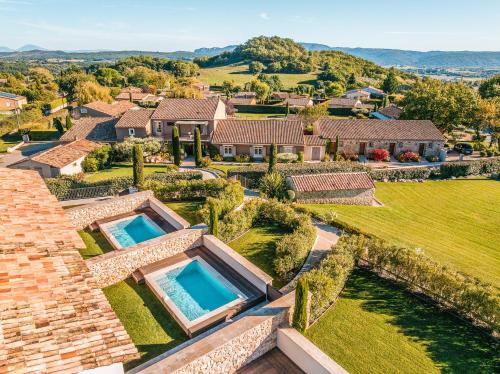 an aerial view of a house with two swimming pools at La Bastide Saint Georges & Spa in Forcalquier