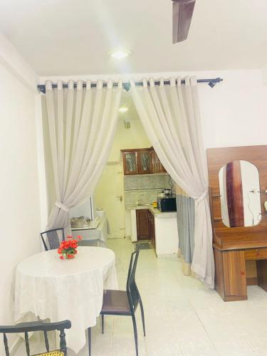 a dining room with a table and a kitchen at Seavora Tangalle in Tangalle