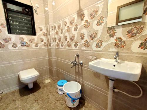 a bathroom with a sink and a toilet at Beach Aura By Lavika Stays in Nagaon