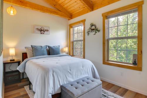 a bedroom with a large bed and two windows at Hike and Unwind, Peaceful Wooded Retreat in Newport in Newport