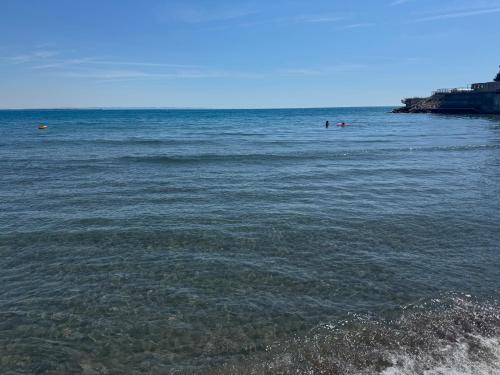 a body of water with people swimming in the ocean at Sea view in Shëngjin