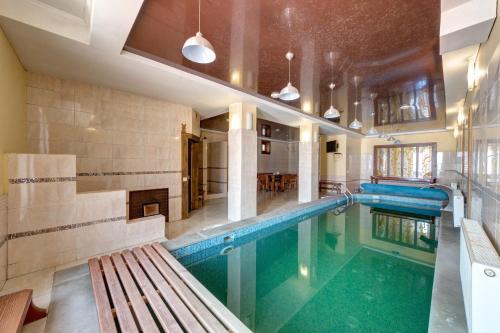 a swimming pool with a bench in a building at Altair Hotel in Bukovel
