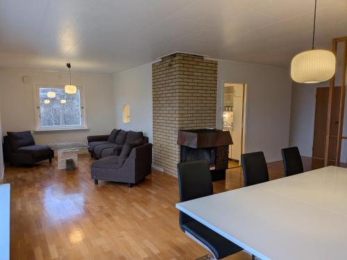 een woonkamer met een tafel, stoelen en een open haard bij Aurora Seaview Escape E33 in Slåttvikstrand
