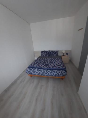 a small bedroom with a bed in a room at Appartements et studios du Pilat in Saint-Julien-Molin-Molette