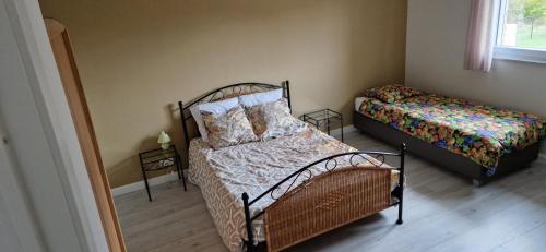 a small bedroom with two beds and a window at Basecamp18 in Lommel