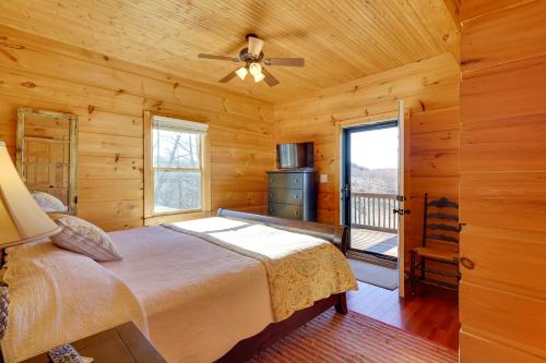 a bedroom with a bed and a ceiling fan at Decks and Panoramic Views Rustic Sparta Cabin in Sparta