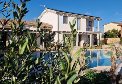 a villa with a swimming pool and a house at Imperyal case vacanze Sud Sardegna in Giba