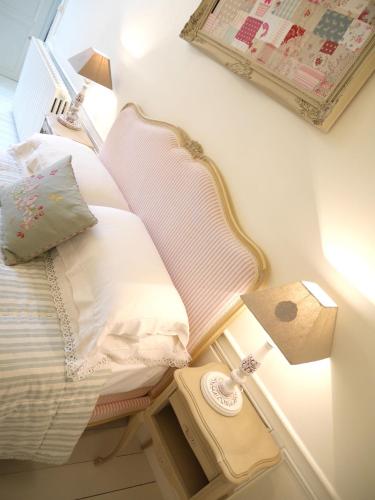a bedroom with a bed with pillows and a lamp at L'Arbre D'Ange in Montmorillon