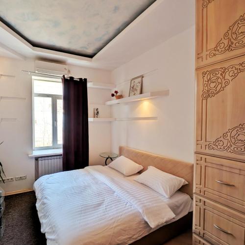a bedroom with a bed and a window at Kyiv Sky Apartment in Kyiv