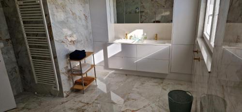 a white bathroom with a sink and a mirror at Basecamp18 in Lommel
