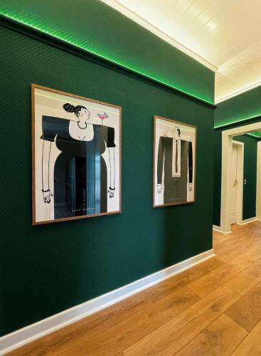 a room with green walls and two pictures on the wall at Zur Alten Stadt in Warendorf