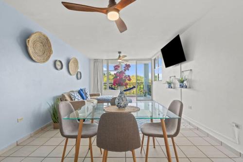 a dining room with a glass table and chairs at Santorini Coastal Vibe Apartment in Costa Brava Ceiba in Santa Maria