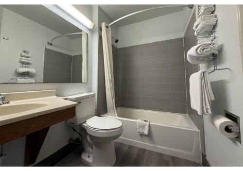 a white bathroom with a toilet and a sink at Conn Brown Harbour Inn Aransas Pass Corpus Christi in Aransas Pass