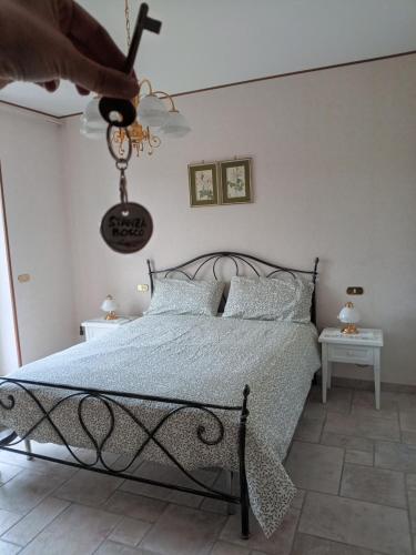 a bedroom with a bed and a person holding a ceiling fan at Casa Bea in Castiglione