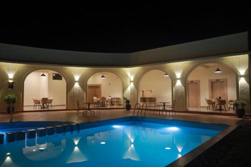 a swimming pool in a house with lights at Serene Kabini Wild lodge in Kabini River