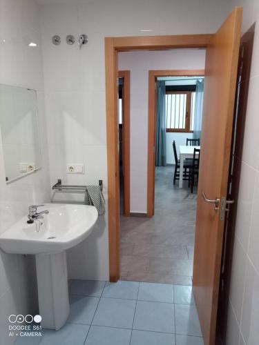 a bathroom with a sink and a mirror and a table at Ca L'Esparter in Bocairent