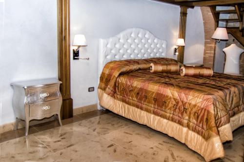 a bedroom with a bed and a nightstand with two lamps at B&B Casa Dilillo in Foggia