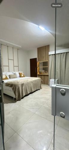 a bedroom with a bed in a room with at Pousada Vista Encantada Preá in Cruz