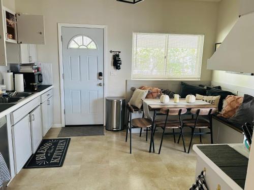 a kitchen with a table with chairs and a couch at Chester Casa in Niles