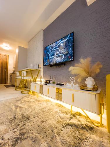 a living room with a tv on a wall at Luxury Studio Apt at 233 Boulevard Cantonment-Accra in Accra