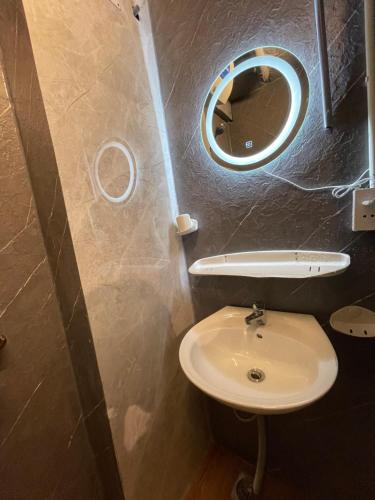 a small bathroom with a sink and a mirror at Ubuntu Central Stay 57 Hang Be in Hanoi