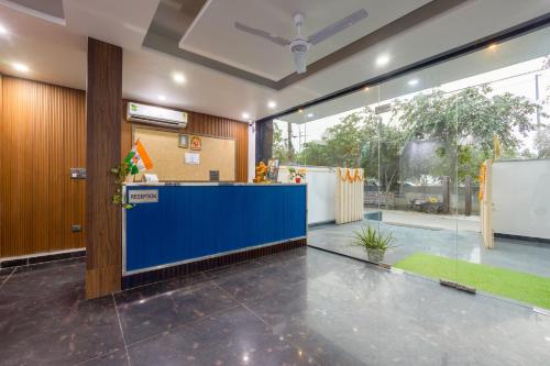 a lobby with a blue counter in a building at Hotel Aura Grand sector 63A Noida I Couple Friendly in Noida
