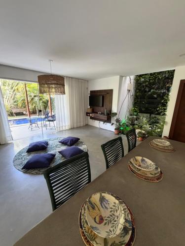 a living room with two tables and a dining room at La Reserve Villa Tropicana in Pipa