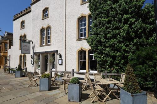 a table and chairs in front of a building at The Stratford Townhouse in Stratford-upon-Avon