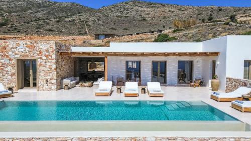 a villa with a swimming pool and a house at Villa Lazuli - Golden Beach in Márpissa