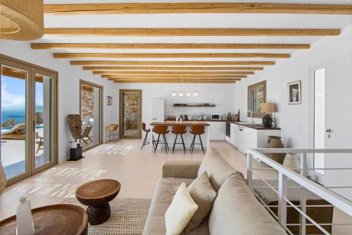 a living room with a couch and a table at Villa Lazuli - Golden Beach in Márpissa