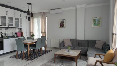 a living room with a couch and a table at Your home in the heart of Batumi, sea in 8th minute in Batumi