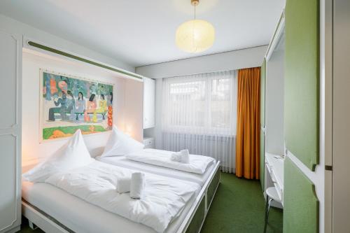 a bedroom with two beds and a painting on the wall at Brentsch B51 in Scuol