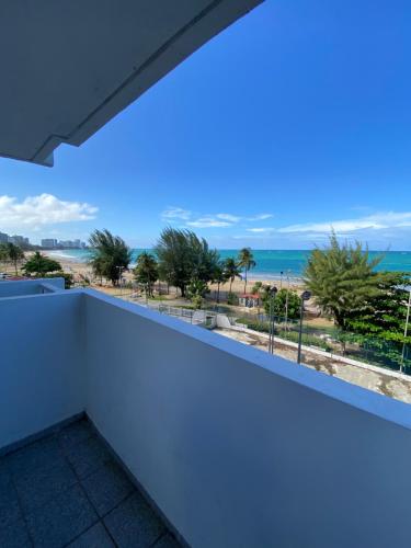 a balcony with a view of the beach at Oceanfront Isla Verde 2B 2B Apartment Paradise Getaway in San Juan