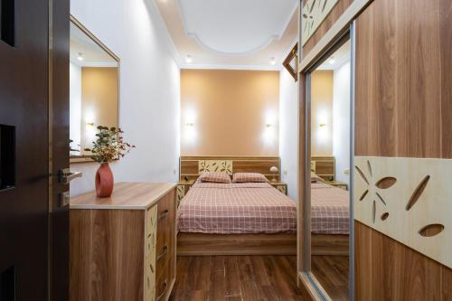 a bedroom with a bed and a mirror at 1 bedroom Modern, Sunny apartment in Amiryan street AM104 in Yerevan