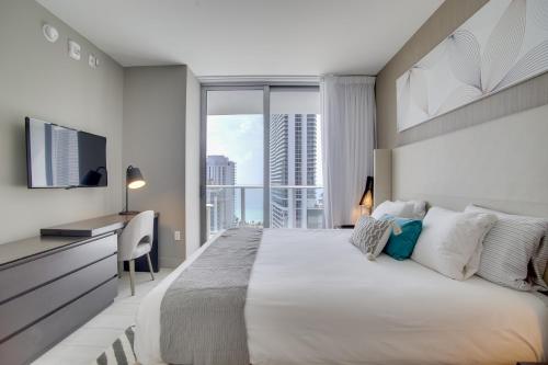a bedroom with a large bed with a large window at Upscale Condo w/ Pool Access in Hyde Beach House! in Hollywood