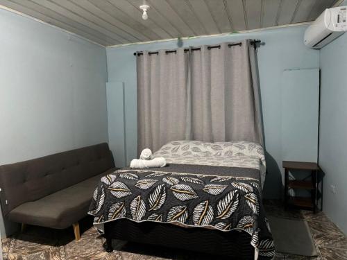 a bedroom with a bed and a curtain at Apartamentos M&M in Fortuna