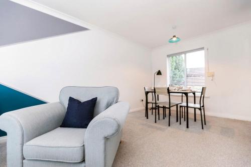a living room with a chair and a table at Cherry House in Durham