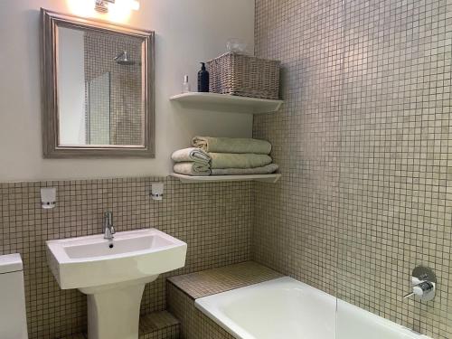 a bathroom with a sink and a toilet and a mirror at 1 Bed in Ullswater 94064 in Watermillock