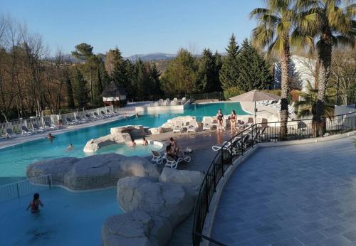 a large swimming pool with people in the water at Domaine de Fayence in Fayence