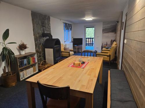 a living room with a wooden table and a couch at Apartmány Lebedín in Nová Ves